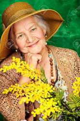 26210008-portrait-of-a-beautiful-elderly-woman-with-mimosa-flowers-happy-old-age